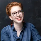 headshot of Glynnis Ritchie, a woman with short red hair and black glasses